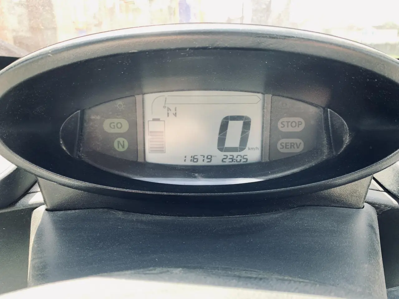 Vue rapprochée du tableau de bord numérique de la Renault Twizy blanc, affichant vitesse et niveau de batterie.
