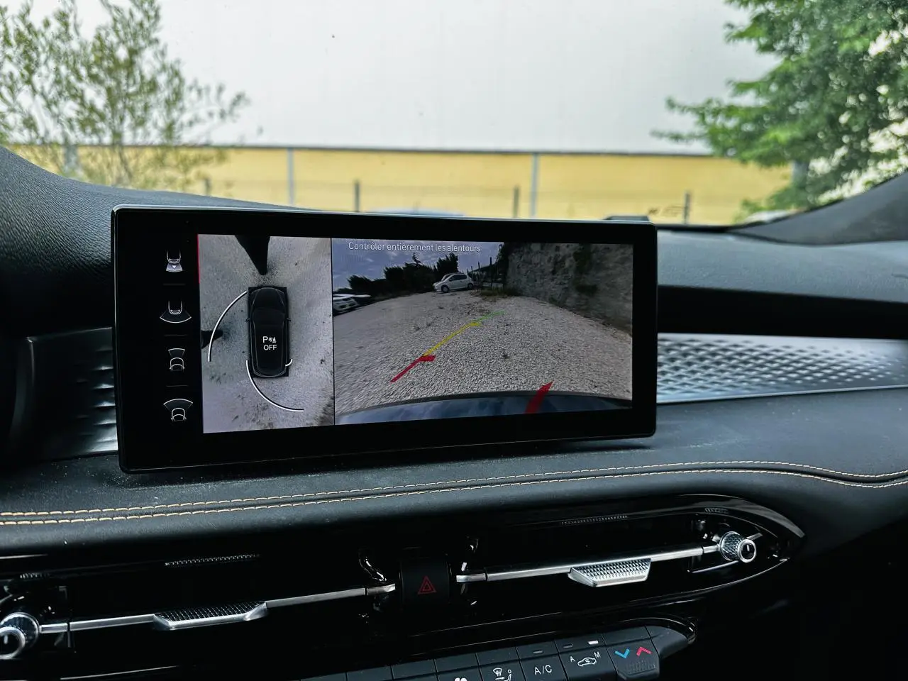 Écran tactile intérieur de l'Alfa Romeo Tonale 2024 montrant la caméra de recul et l'aide au stationnement.