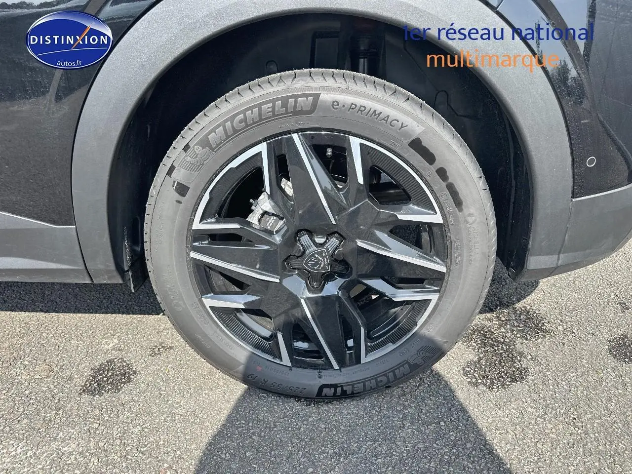 Gros plan sur la roue avant droite avec jante alu noire et argentée du Peugeot 3008 noir Perla Nera Meta.