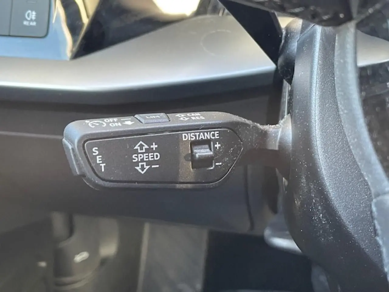 Le levier de régulateur de vitesse sur le côté gauche du volant d'une Audi A3 argentée, version 2022.