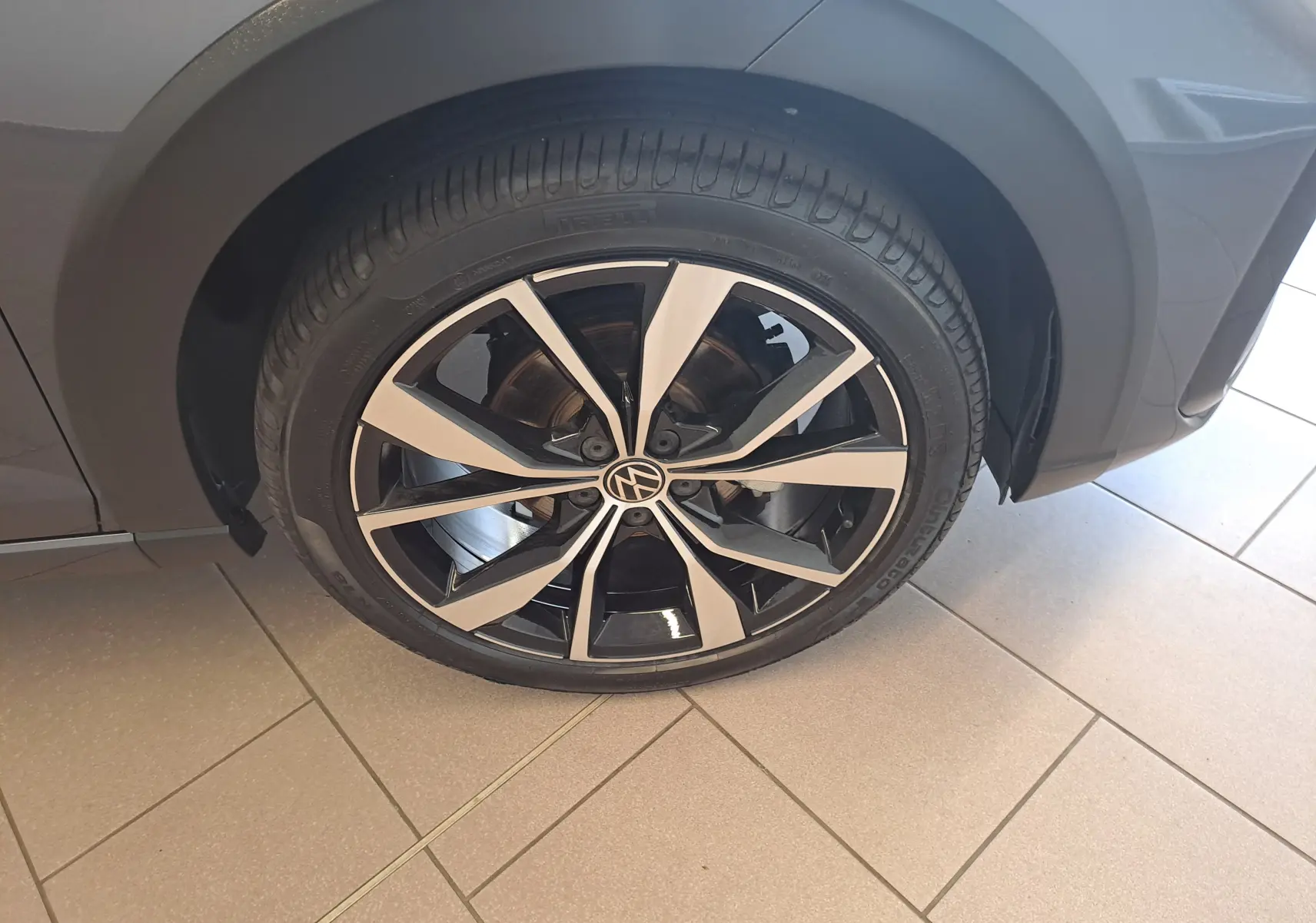 Gros plan sur la jante alliage 18 pouces "Misano" noir et argent du Volkswagen Taigo gris cendre, côté gauche.