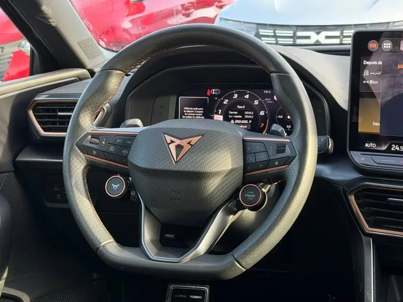 Vue rapprochée du volant multifonction du SEAT LEON 2025, avec logo Cupra et tableau de bord numérique.