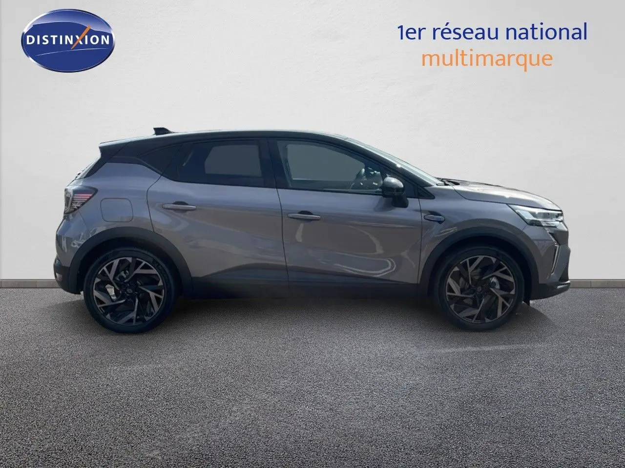 Profil côté gauche du Renault Captur E-Tech hybride 2025 gris cassiopée avec toit noir et jantes noires stylisées.