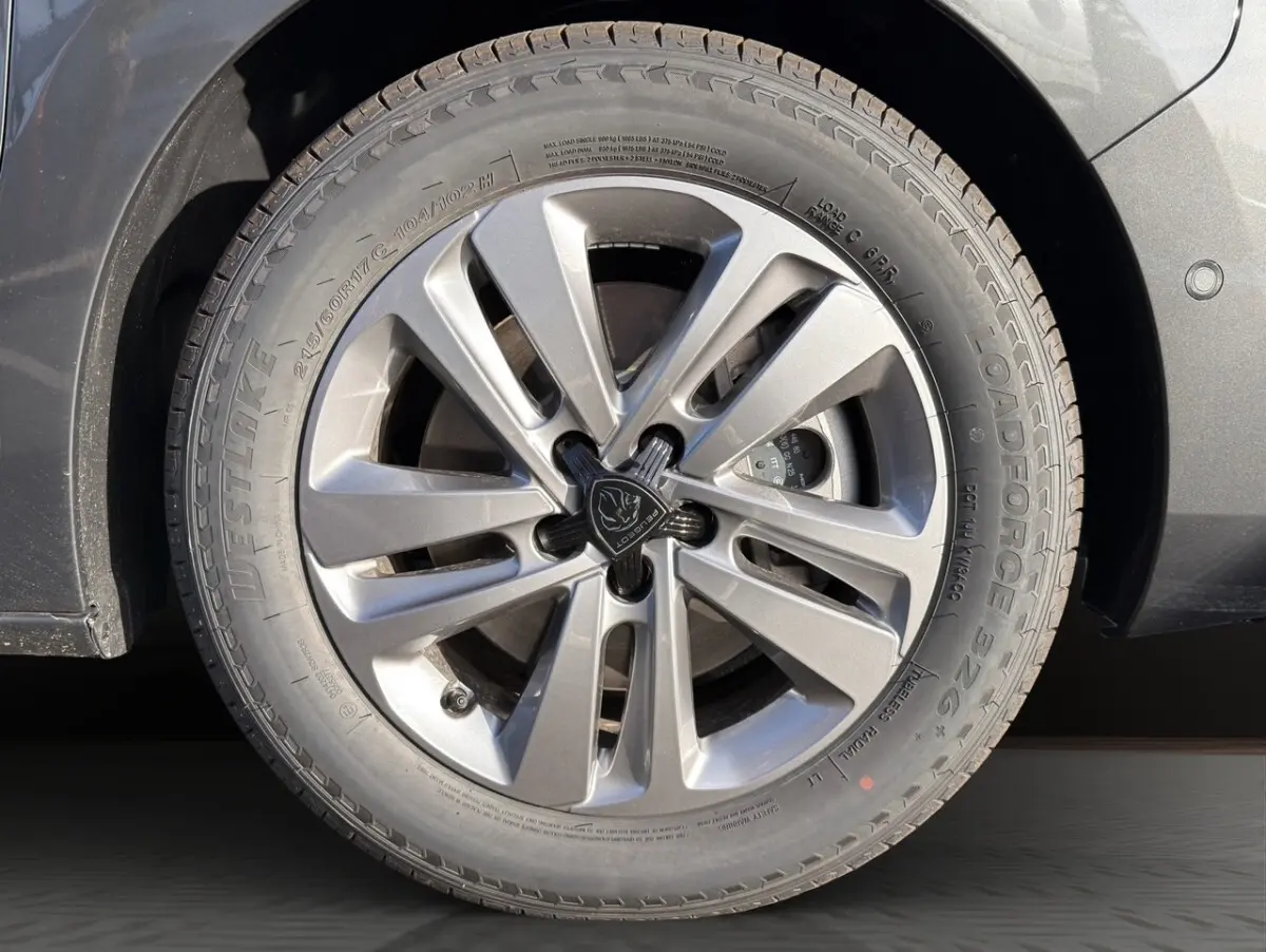 Gros plan sur la roue avant droite gris foncé du Peugeot Expert Fourgon avec jante alliage et logo central Peugeot.