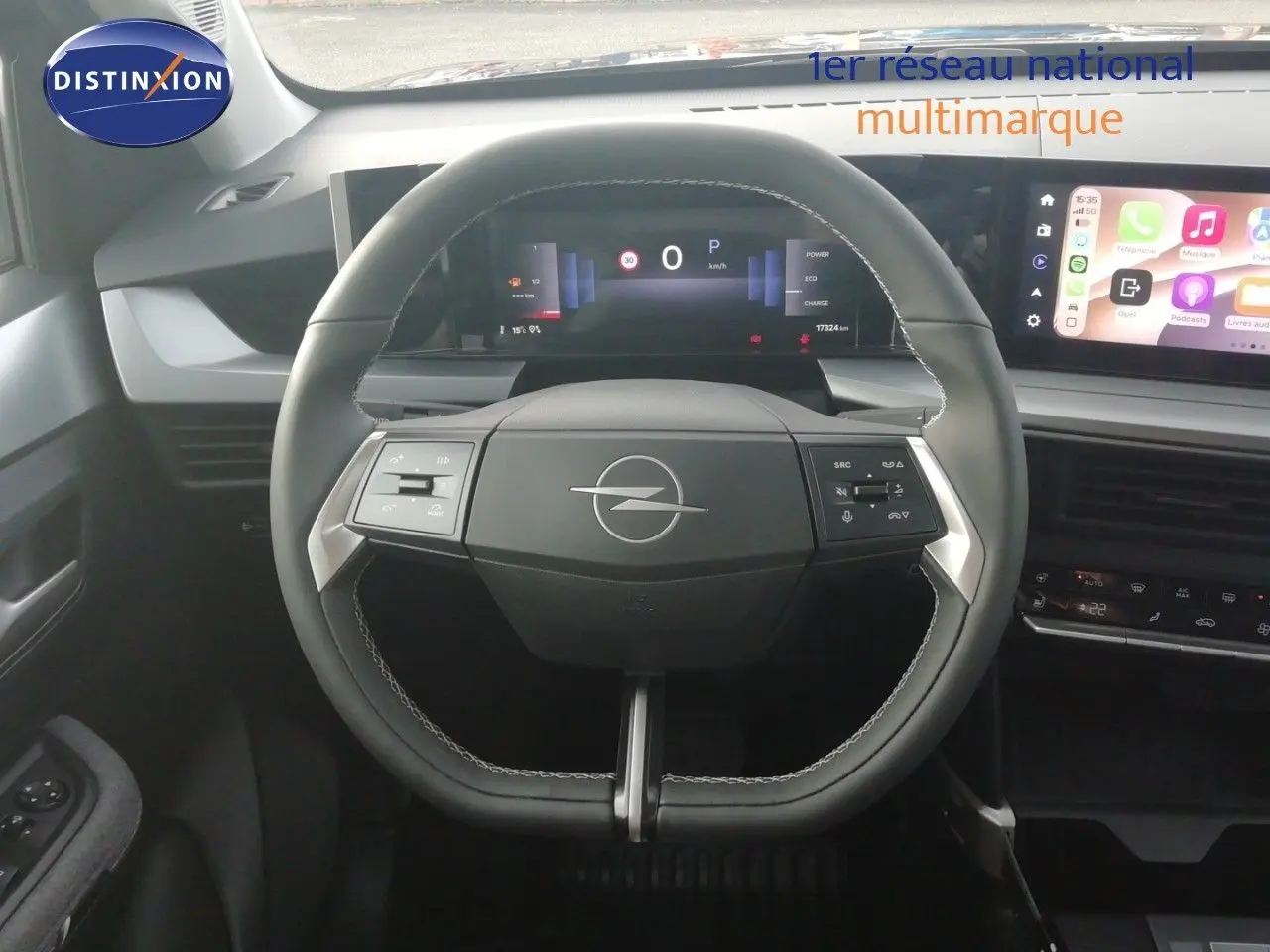 Vue intérieure centrée sur le volant noir de l'Opel Frontera 2025 avec tableau de bord numérique et écran tactile latéral.