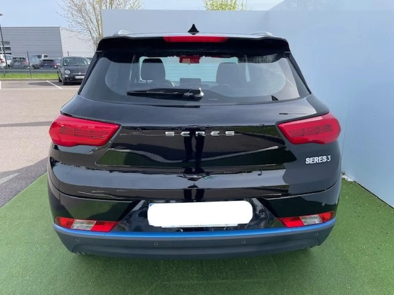 Vue arrière du SUV électrique SERES 3 noir métal, avec feux rouges et logo distinctif bien visibles.