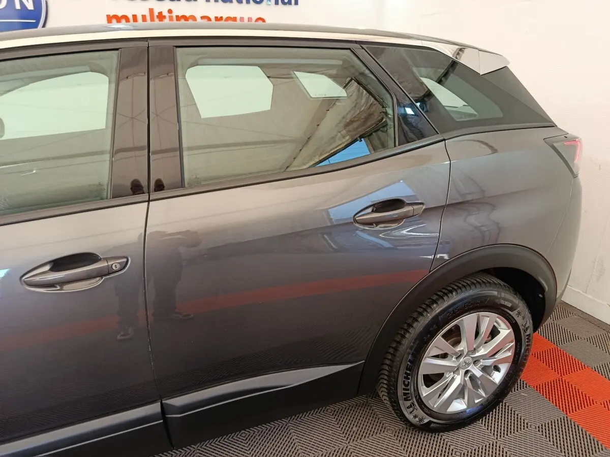 Vue côté droit arrière du Peugeot 3008 gris foncé 2022, mettant en valeur la roue et la ligne de caisse.