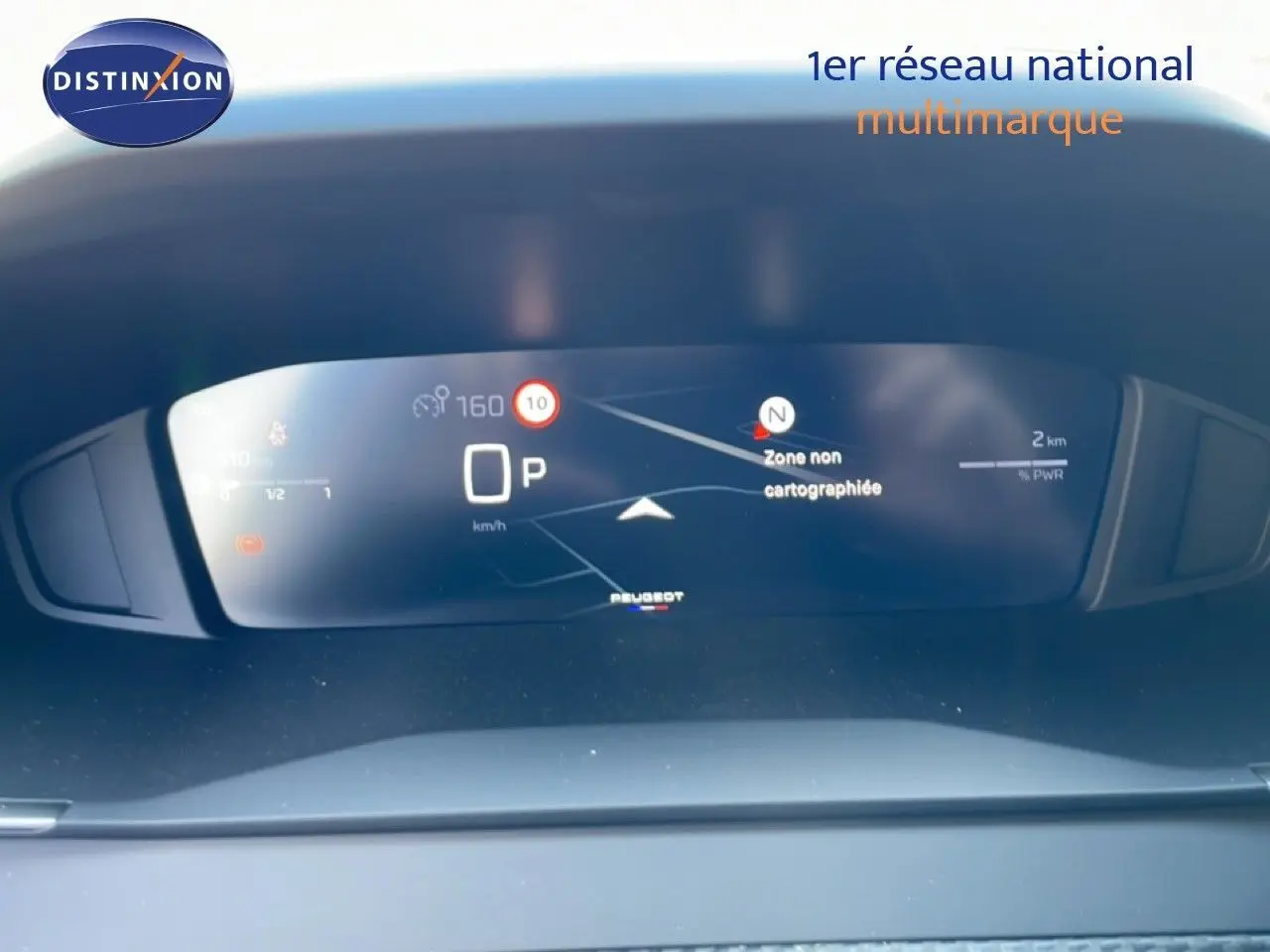 Tableau de bord numérique de Peugeot 208 Hybrid 110ch en vue frontale, affichant la navigation et la vitesse à l'arrêt.