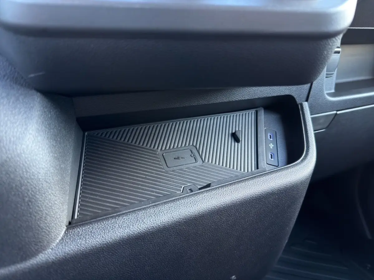 Gros plan sur le rangement réfrigéré noir dans l’habitacle du Renault Master blanc, avec ports USB visibles.