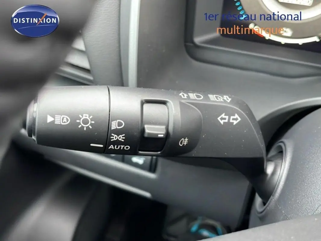 Commande des feux en gros plan à gauche du volant dans l'habitacle du Nissan Qashqai noir 2025, version N-Connecta.