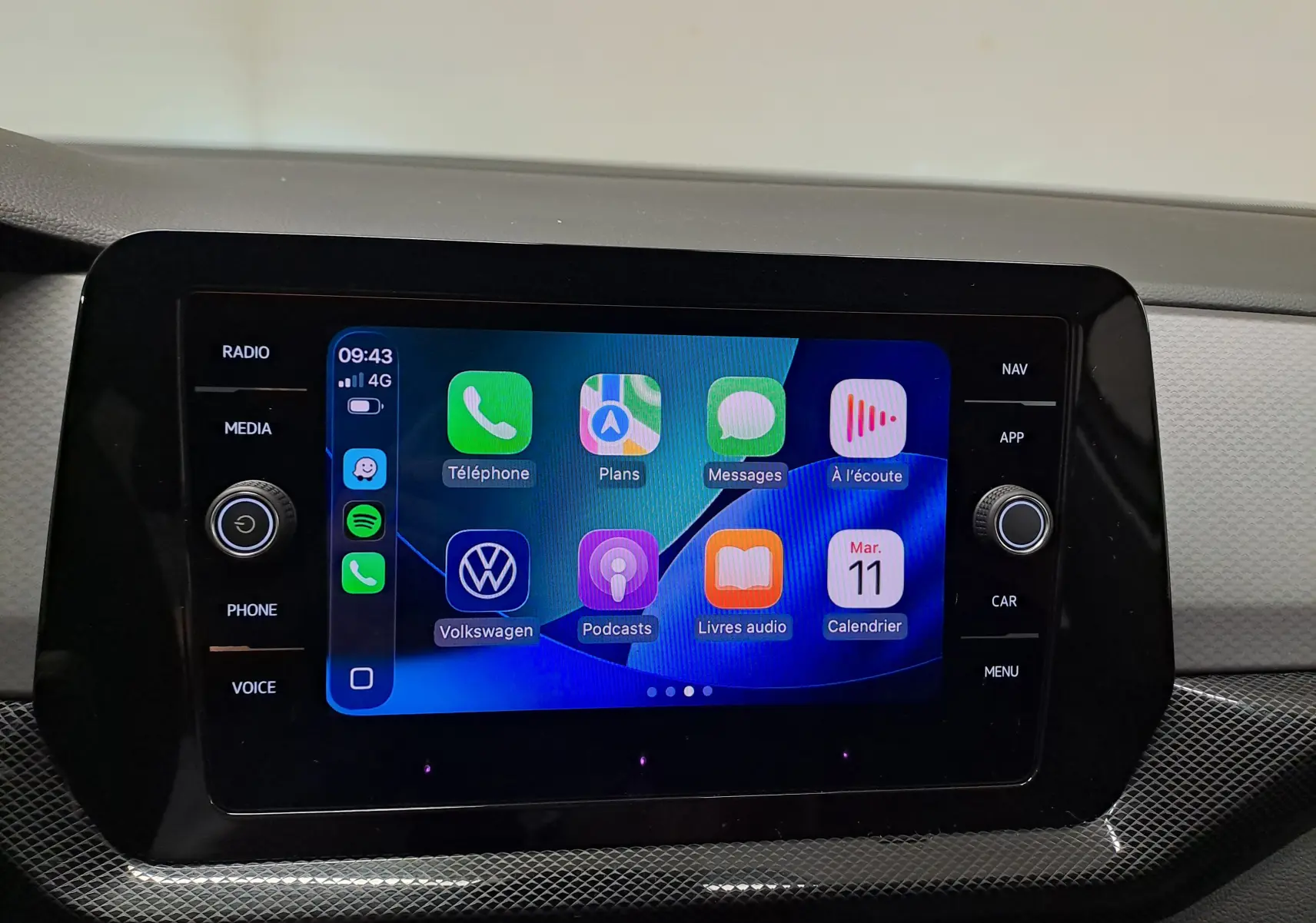 Écran tactile central du Volkswagen T-Cross 2024 affichant l'interface smartphone avec applications colorées.