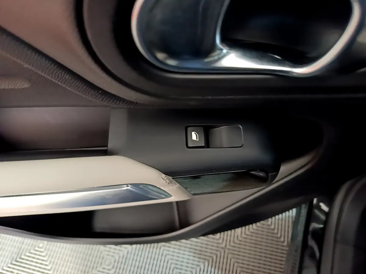 Détail de la poignée intérieure et bouton de lève-vitre côté gauche du Citroën C5 Aircross Hybrid noir 2021.