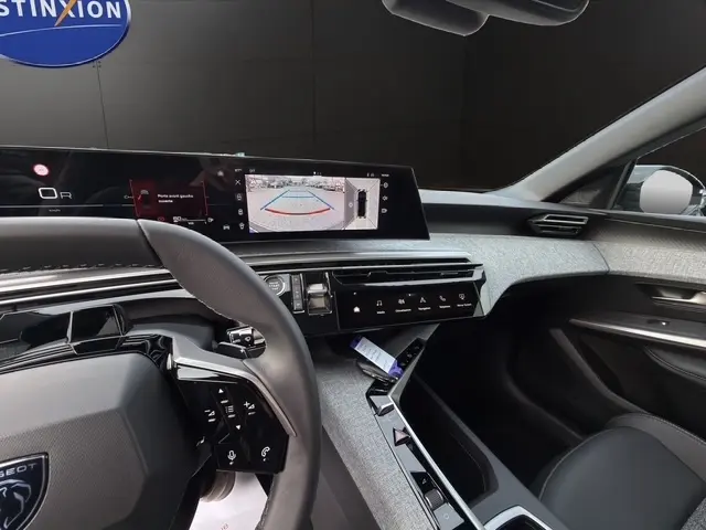 Vue intérieure côté conducteur du Peugeot 3008 hybride 2026, avec écran tactile central affichant la caméra de recul.