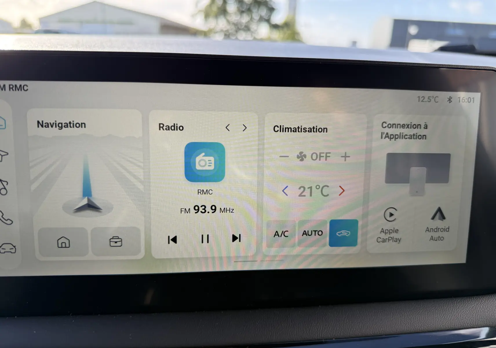 Écran tactile central de la MG3 1.5 Hybrid+ 195 Luxury affichant navigation, radio FM et climatisation à 21°C.