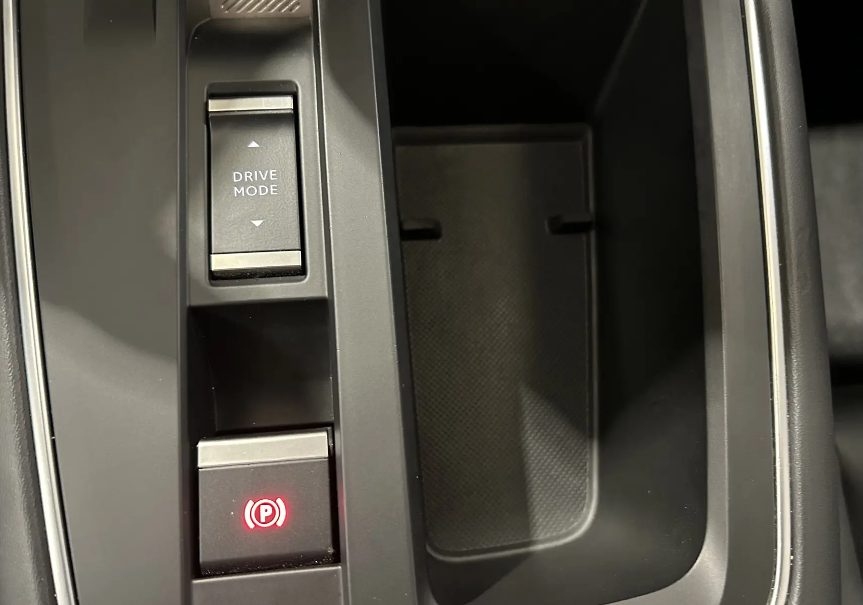 Détail de la console centrale grise du Citroën C5 Aircross avec bouton Drive Mode et frein à main électronique allumé.