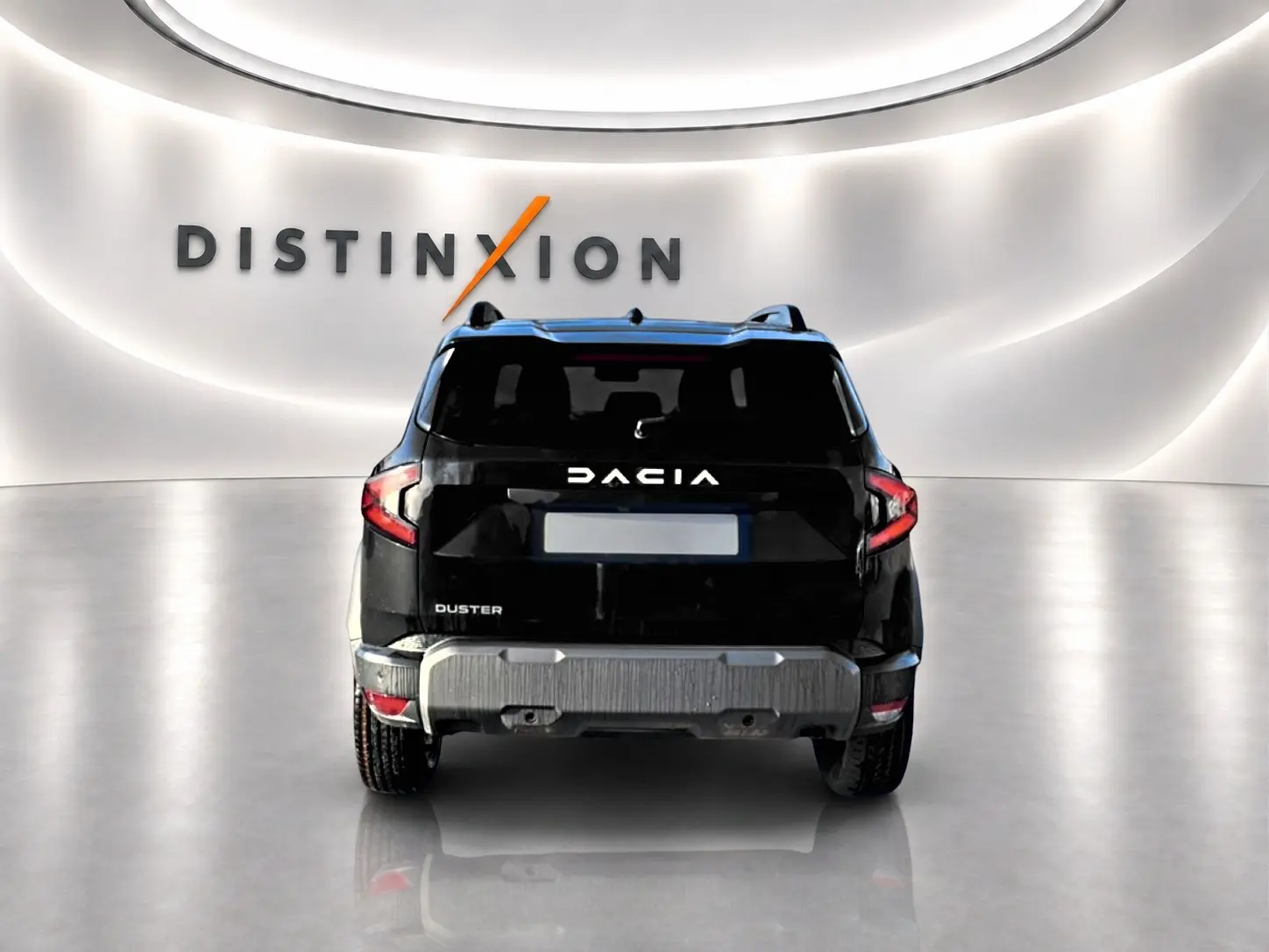 Vue arrière du Dacia Duster noir 2026 avec logo blanc et barres de toit visibles dans un showroom lumineux.