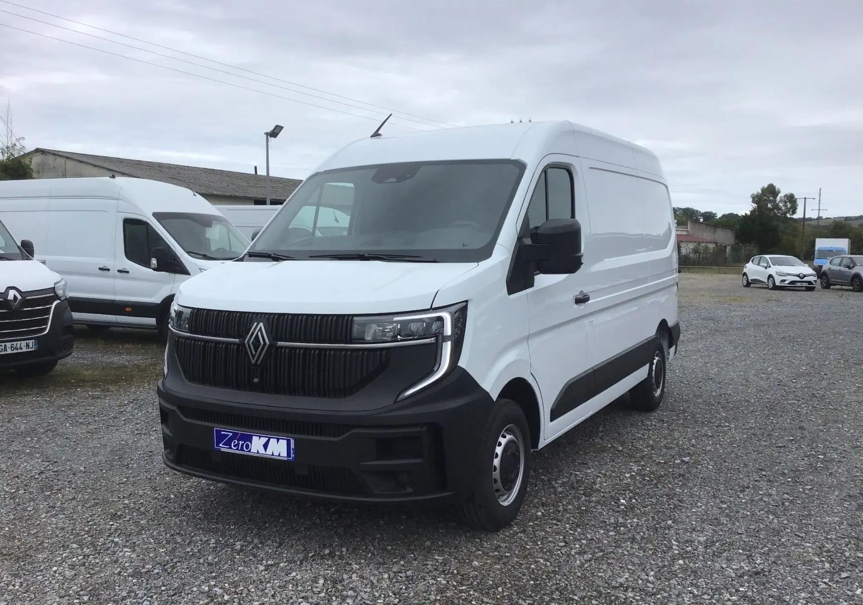 Renault Master blanc en vue 3/4 avant droit, avec calandre noire et pare-chocs avant contrasté noir.