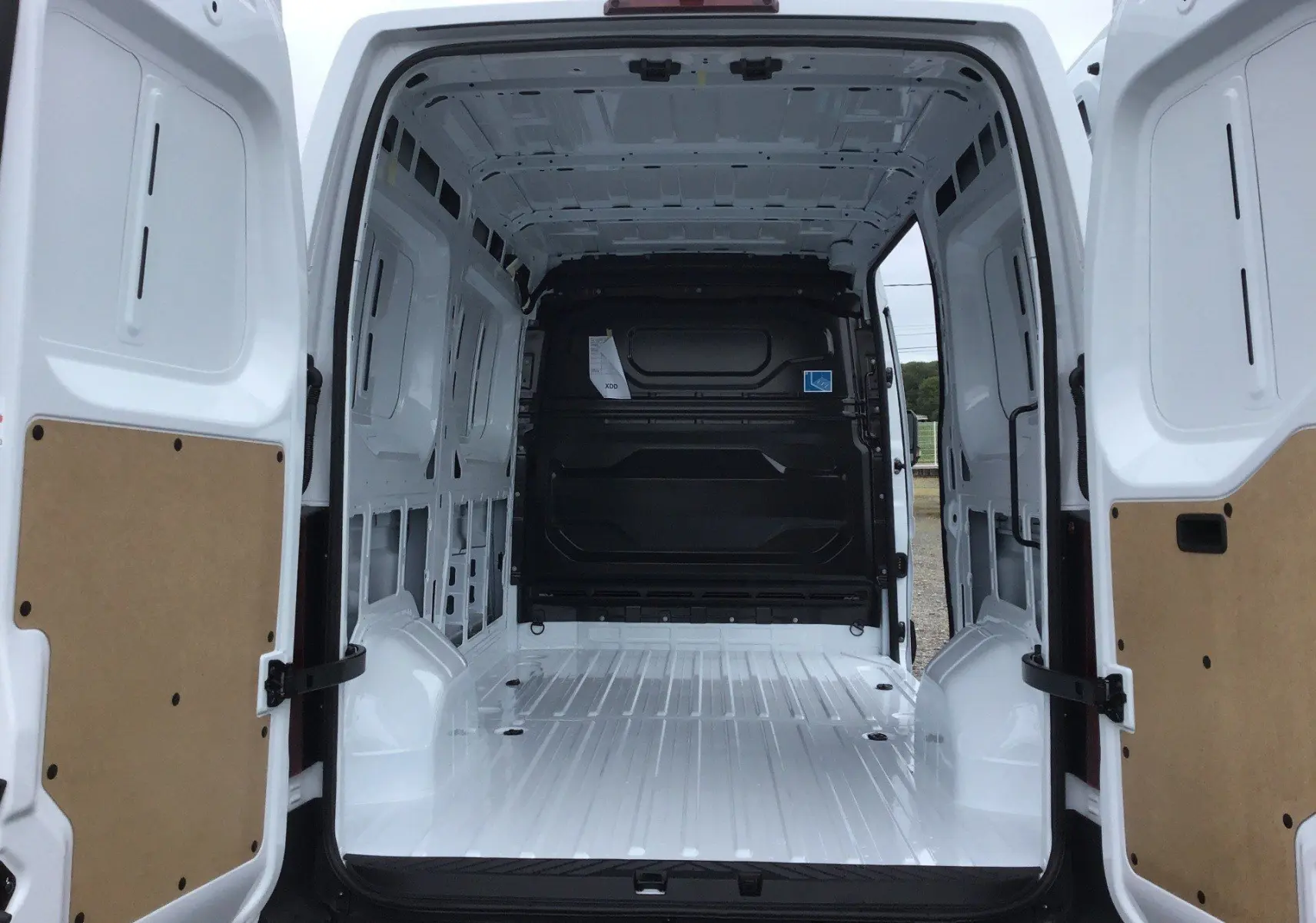 Vue arrière intérieure du Renault Master blanc L2H2 2025, montrant l’espace de chargement vide avec portes ouvertes.