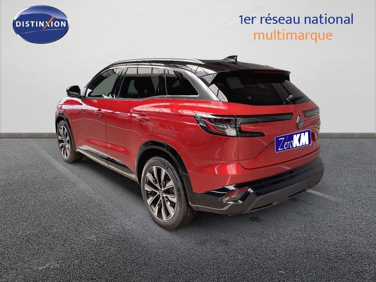 Vue 3/4 arrière droite d'un Renault Austral rouge passion avec toit noir et jantes alliage biton.