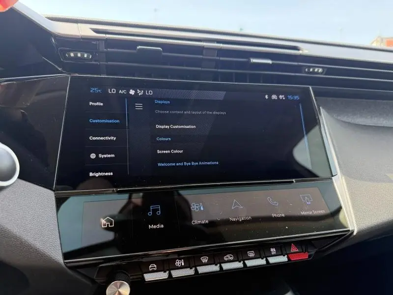 Vue rapprochée de l’écran tactile central du tableau de bord de la Peugeot 308 hybride 2025, affichant les réglages de l’écran.