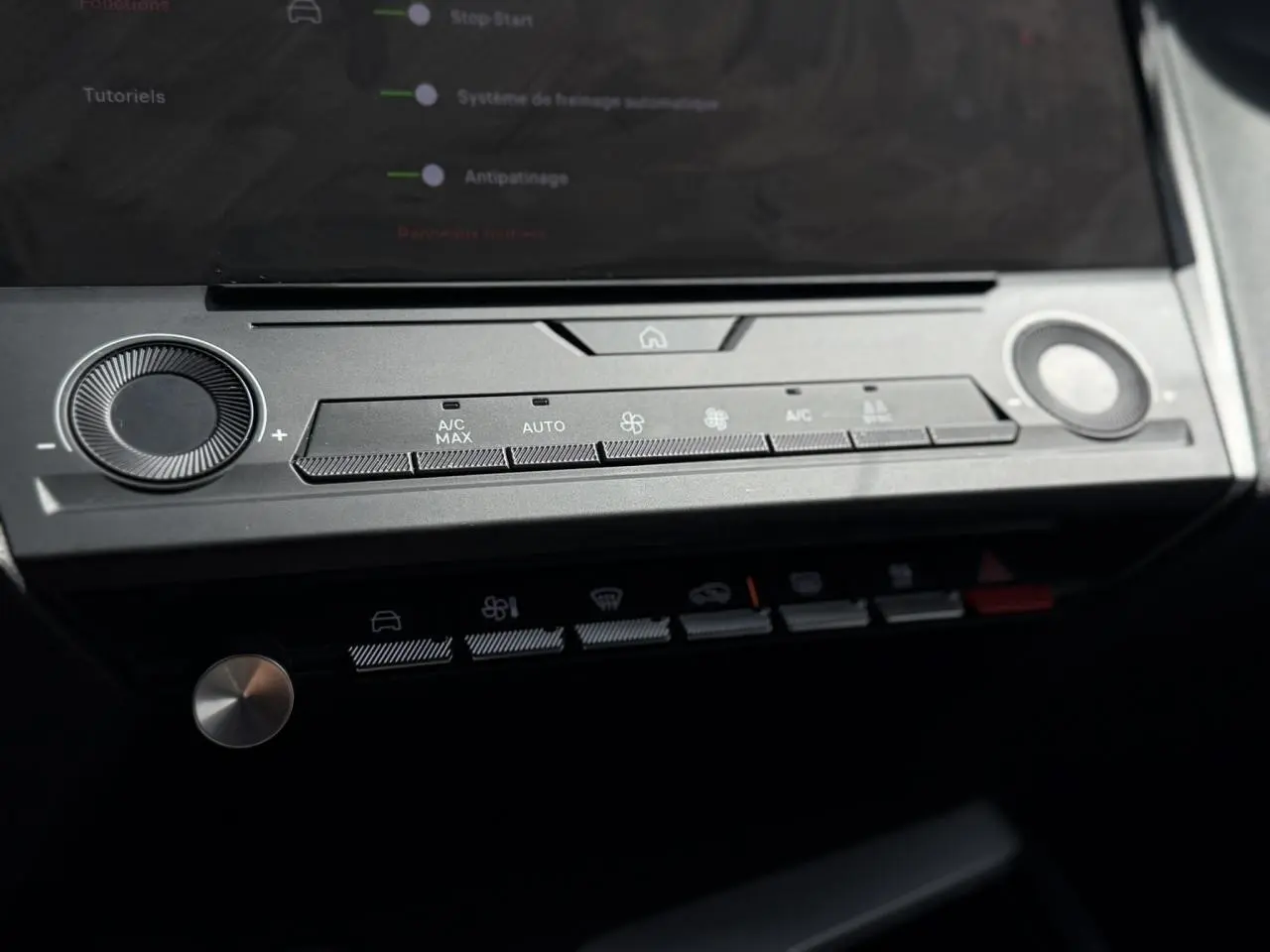 Vue rapprochée de la console centrale de la Peugeot 308 2025 gris Artense, montrant les commandes de climatisation tactile.