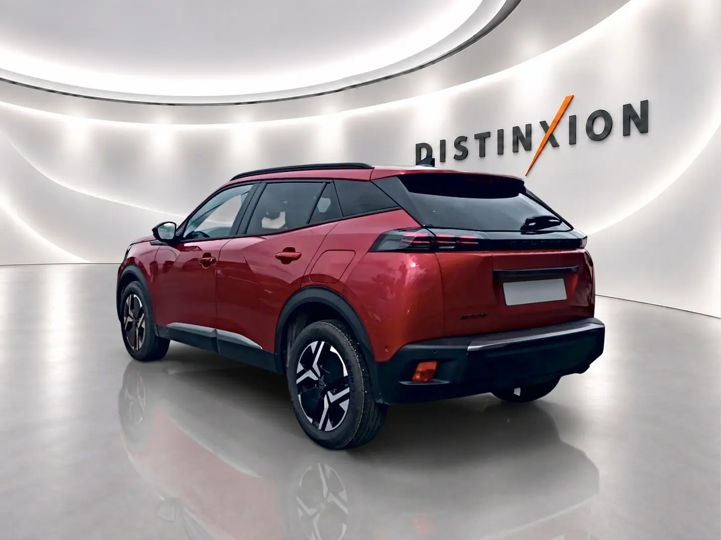 Peugeot 2008 rouge elixir vue 3/4 arrière droit dans un showroom lumineux avec jantes alu et toit noir.