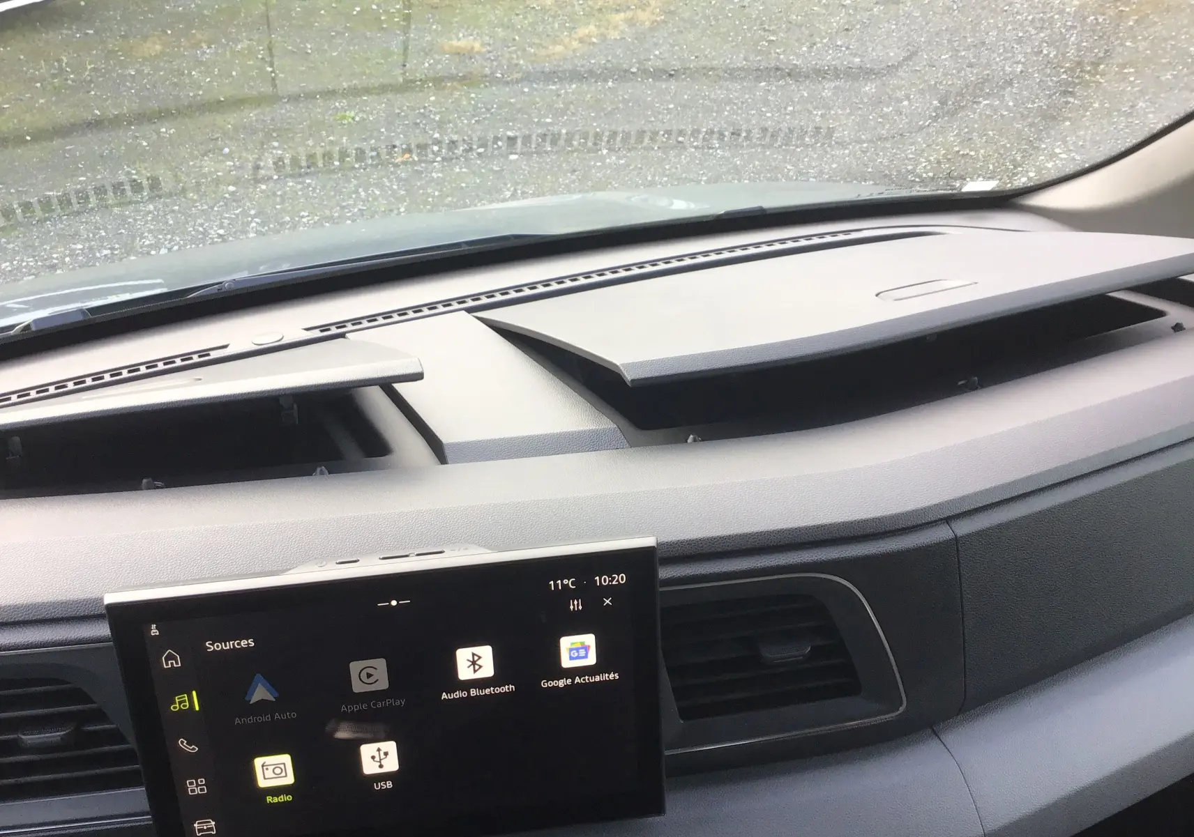 Vue intérieure du tableau de bord du Renault Master L3H2 gris urbain, avec écran tactile OpenR Link 10'' et rangements ouverts.