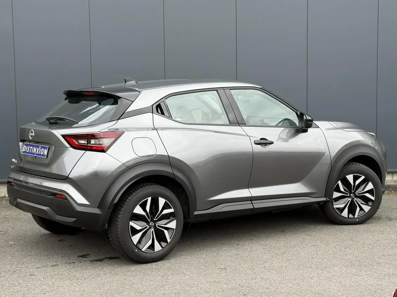 Nissan Juke 2025 gris foncé en vue de profil côté droit, avec jantes noires et détails noirs contrastants.