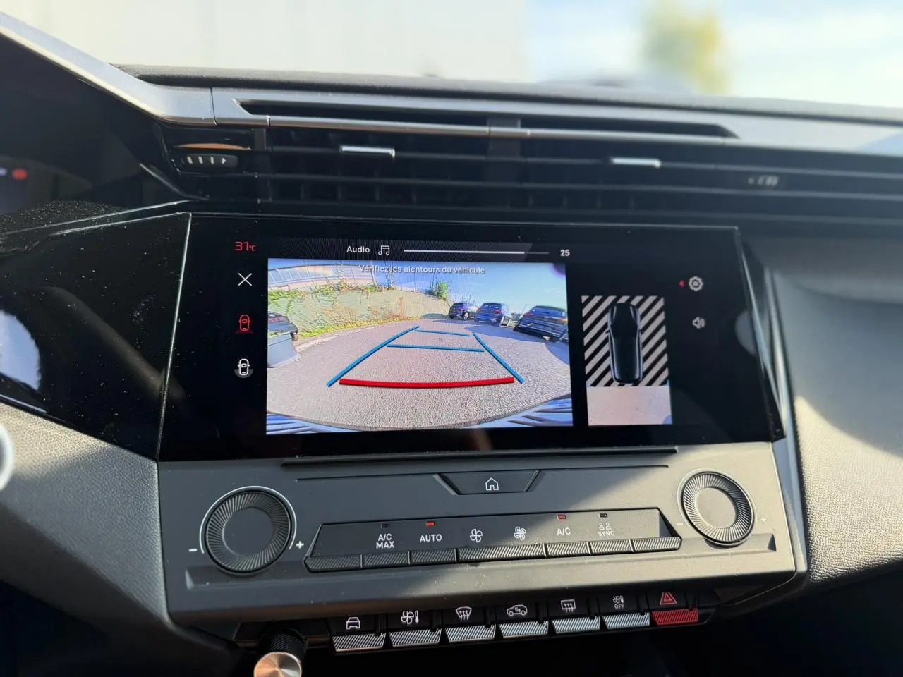 Vue rapprochée de l’écran central tactile affichant la caméra de recul et l’aide au stationnement du Peugeot 308 noir Perla 2025.