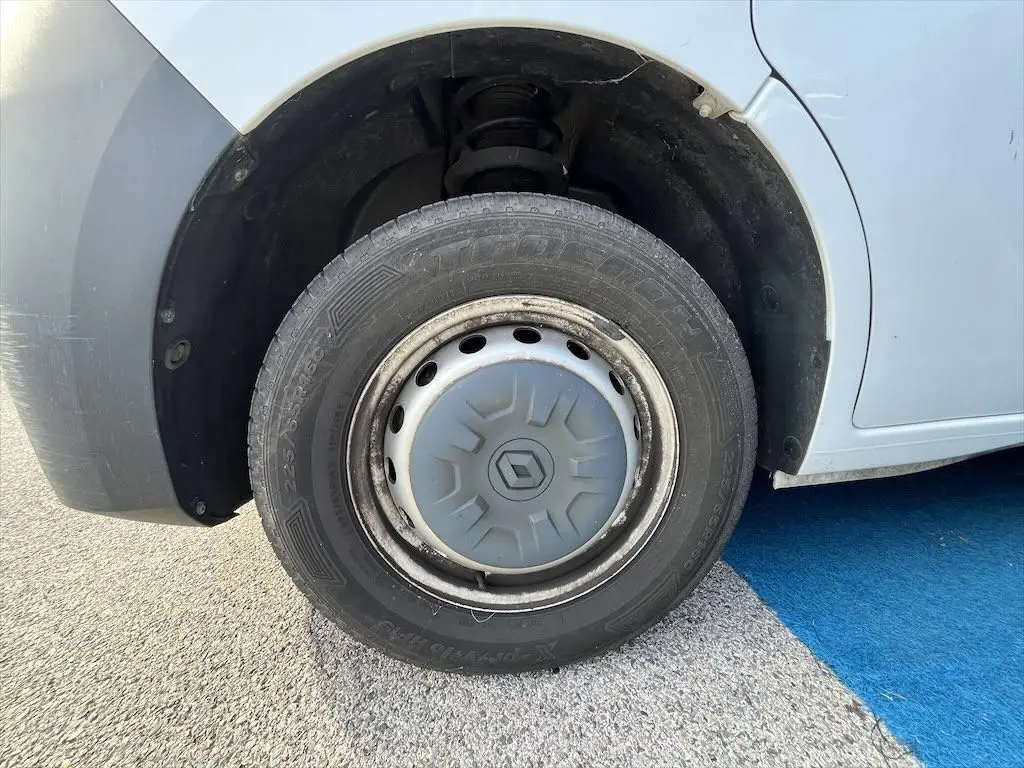 Gros plan sur la roue avant gauche blanche d'un Renault Master 2.3 DCI 135 L2H3 avec enjoliveur d'origine.