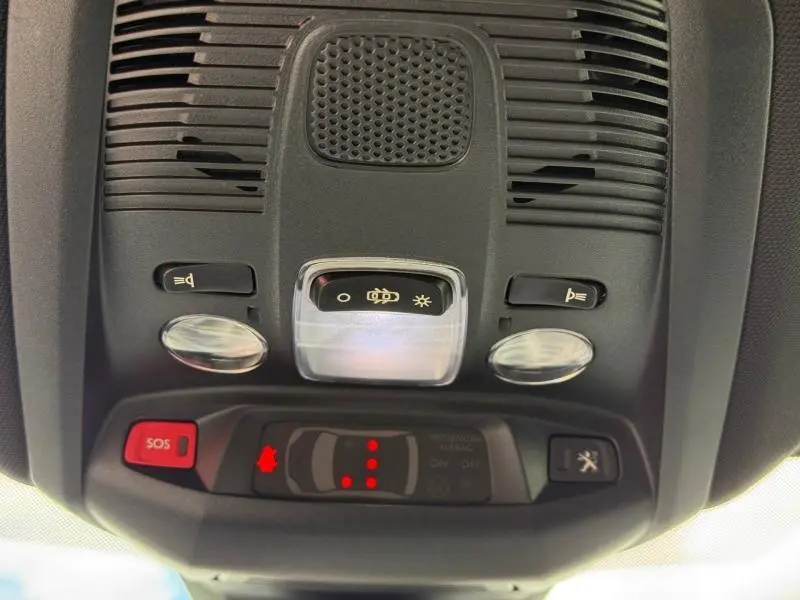 Vue en plongée du plafonnier intérieur du Peugeot 3008 2024, avec boutons d’éclairage et alerte SOS rouge.