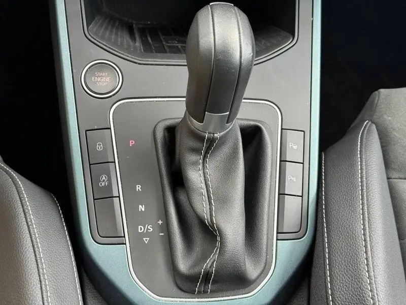 Vue rapprochée du levier de vitesses automatique cuir noir de la SEAT ARONA 1.0 TSI 115ch Xperience, console centrale grise.
