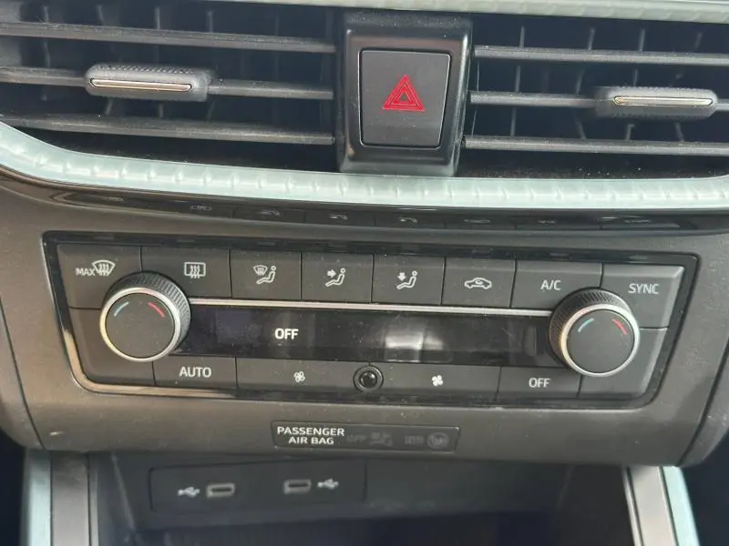 Tableau de bord du SEAT Arona 2025, vue rapprochée sur la console de climatisation automatique bi-zone avec boutons et voyants.