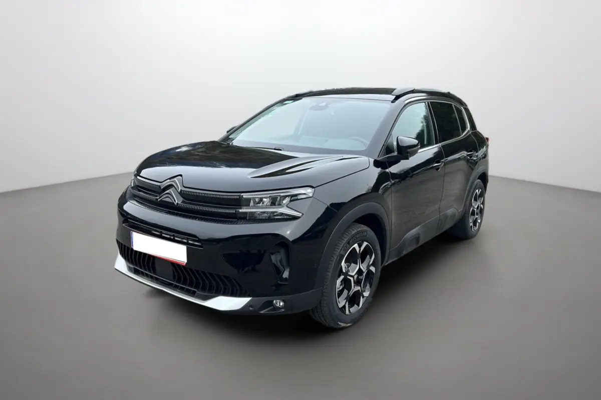 Citroën C5 Aircross Hybrid noir en 3/4 avant droit, avec jantes alu 18 pouces et barres de toit longitudinales visibles.
