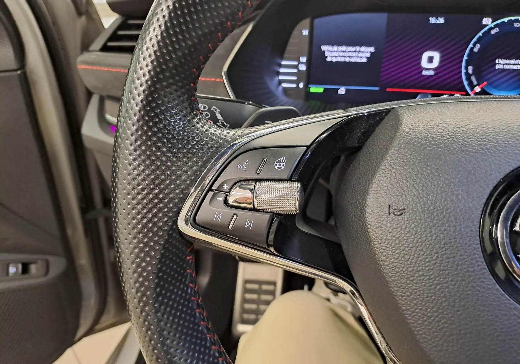 Gros plan sur le volant perforé avec commandes intégrées et tableau de bord numérique de la Skoda Octavia Combi 1.4 TSI PHEV.