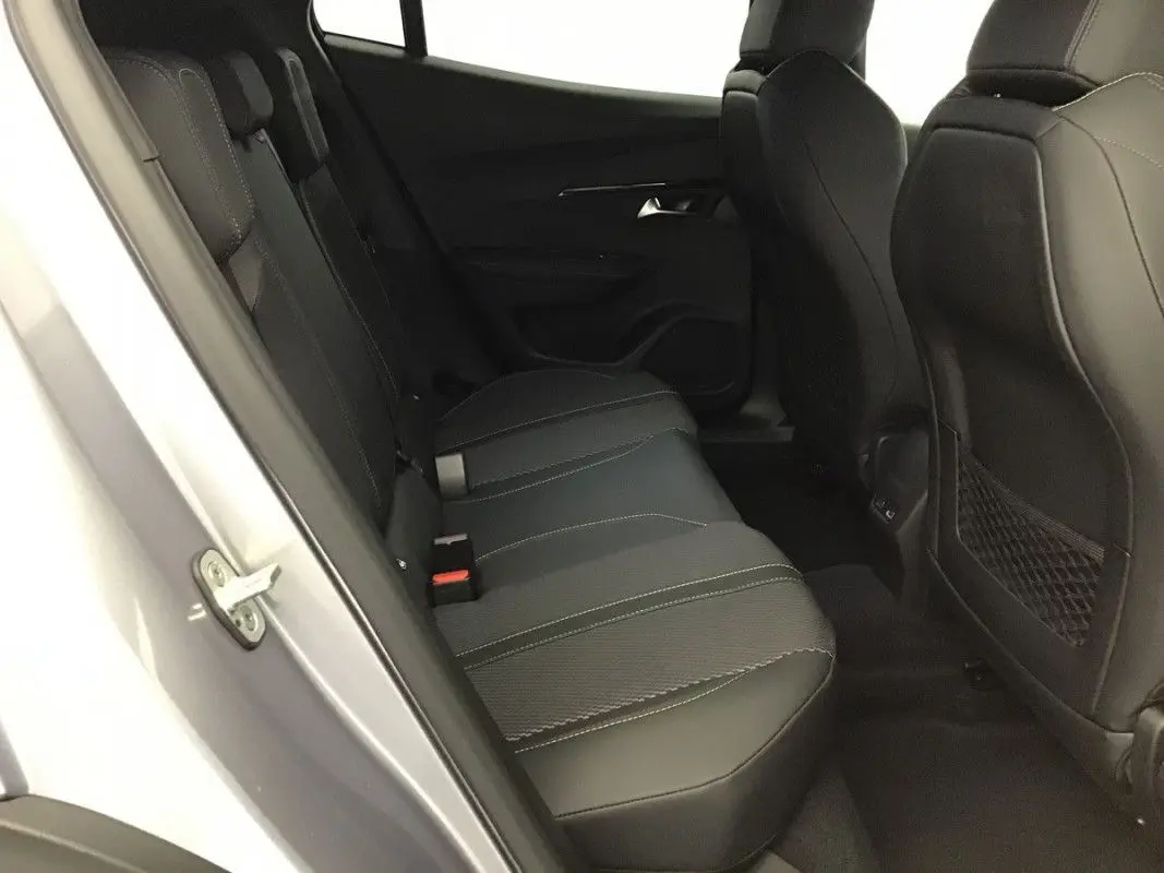 Vue intérieure côté gauche des sièges arrière en cuir noir du Peugeot 2008 Hybrid 145ch GT 2025 gris Artense toit noir.
