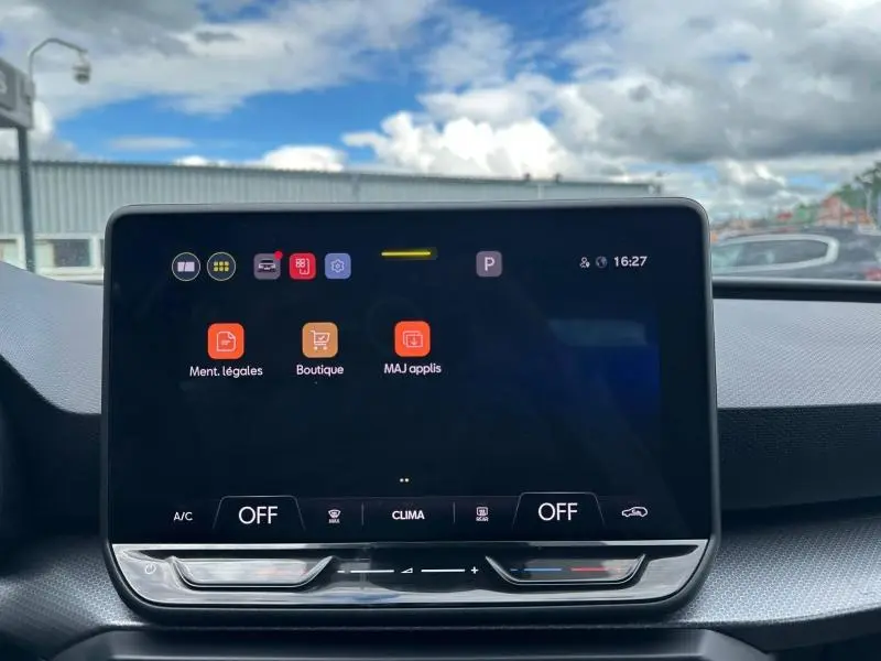 Écran tactile central de la SEAT Leon 2025 affichant le menu des applications, avec tableau de bord gris en arrière-plan.