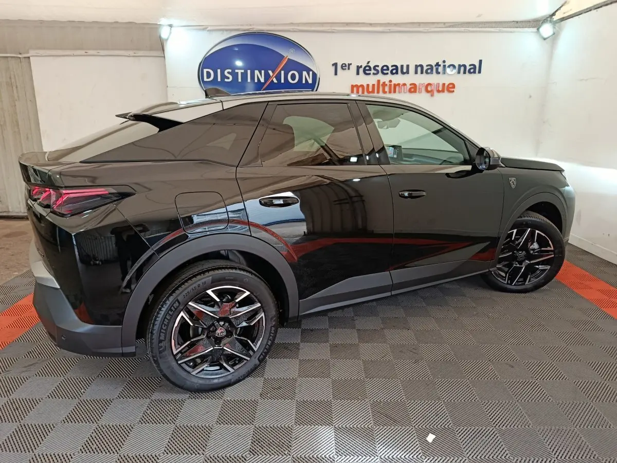 Peugeot 3008 noir vue de profil côté gauche, avec jantes noires et détails modernes sous éclairage intérieur.