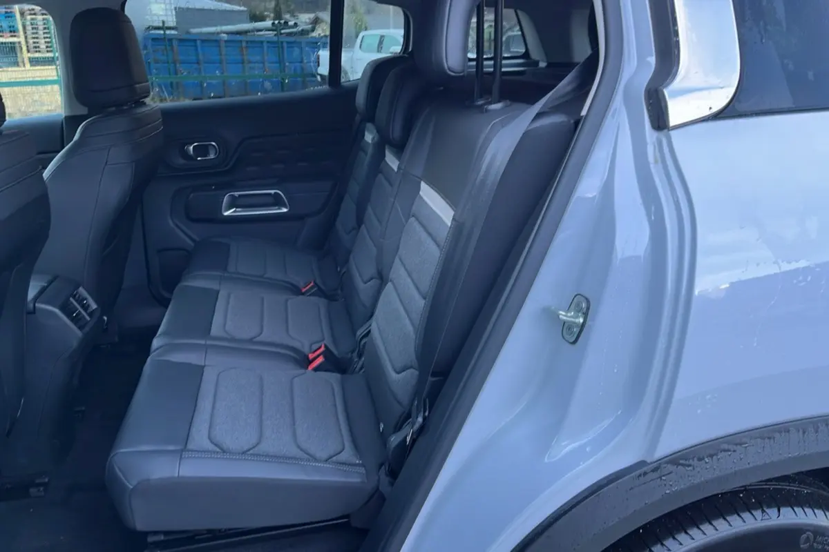 Vue intérieure côté droit montrant les trois sièges arrière individuels en tissu gris du Citroën C5 Aircross Hybrid blanc.