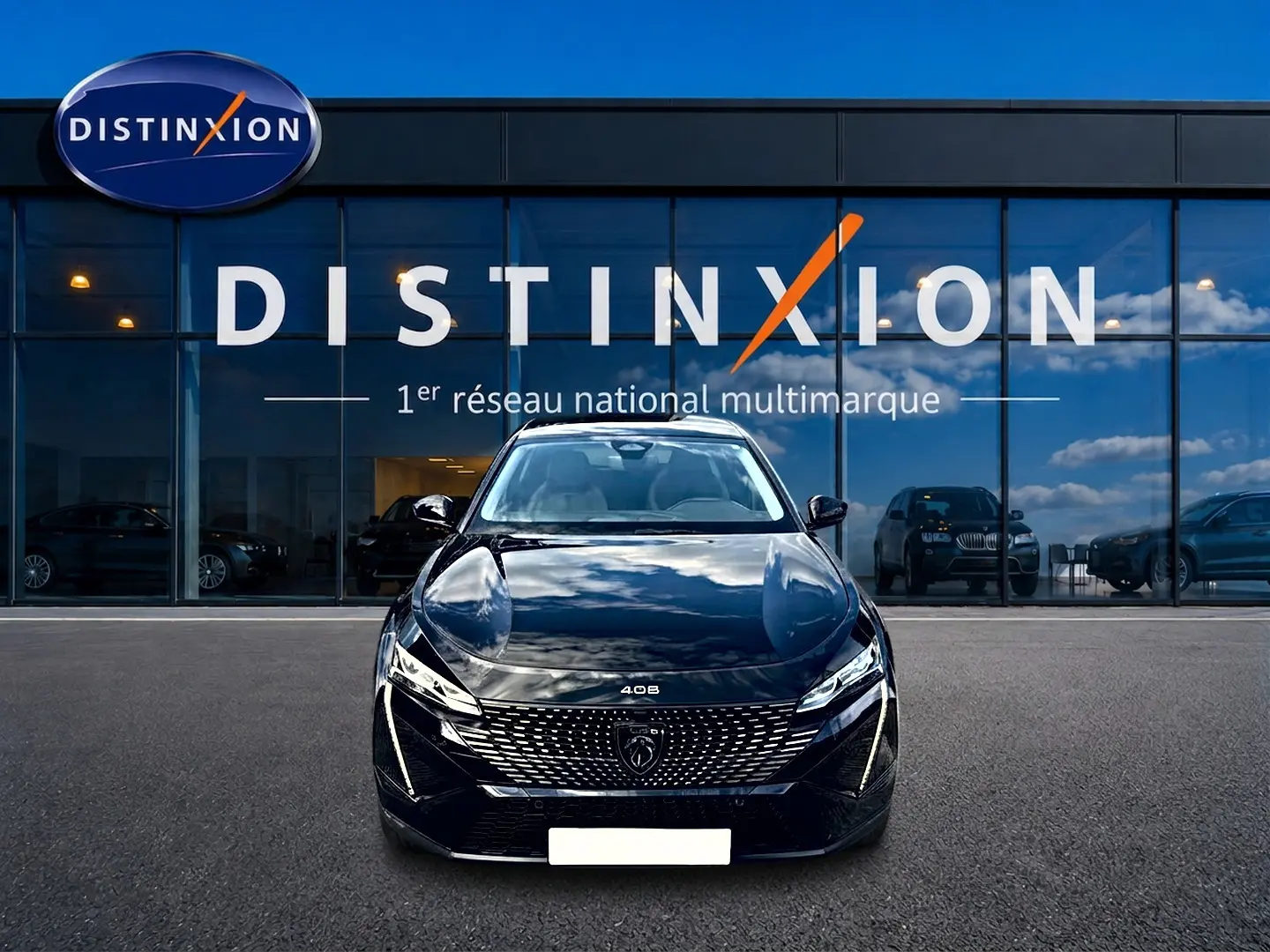 Vue frontale d'une Peugeot 408 Hybrid 145 allure e-dcs6 noire, avec calandre distinctive et phares LED allumés.