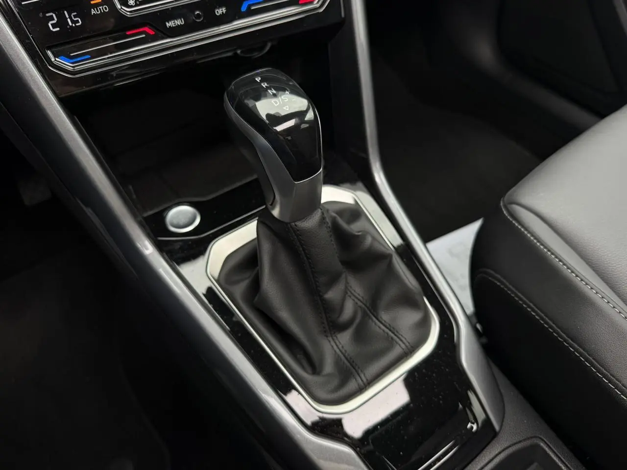 Le levier de vitesses automatique noir et argenté du Volkswagen T-Roc 2024, avec console centrale en finition brillante.