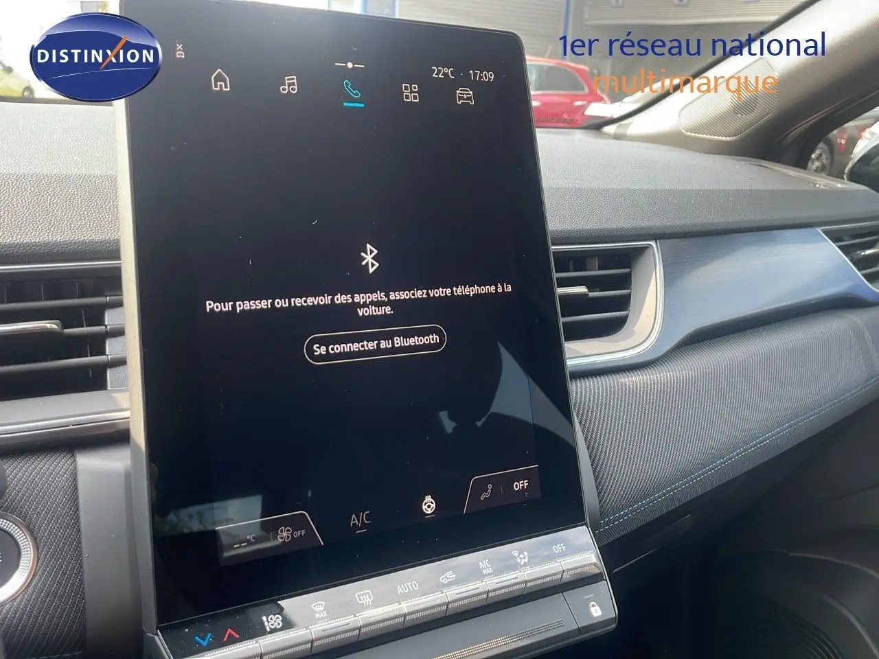 Écran tactile central allumé dans l'habitacle du Renault Captur E-Tech gris Cassiopée, vue côté passager.