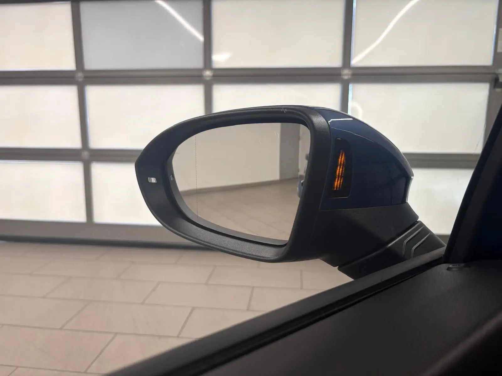 Rétroviseur droit bleu Anémone de Volkswagen Golf 1.5 TSI 2025 avec clignotant intégré allumé.