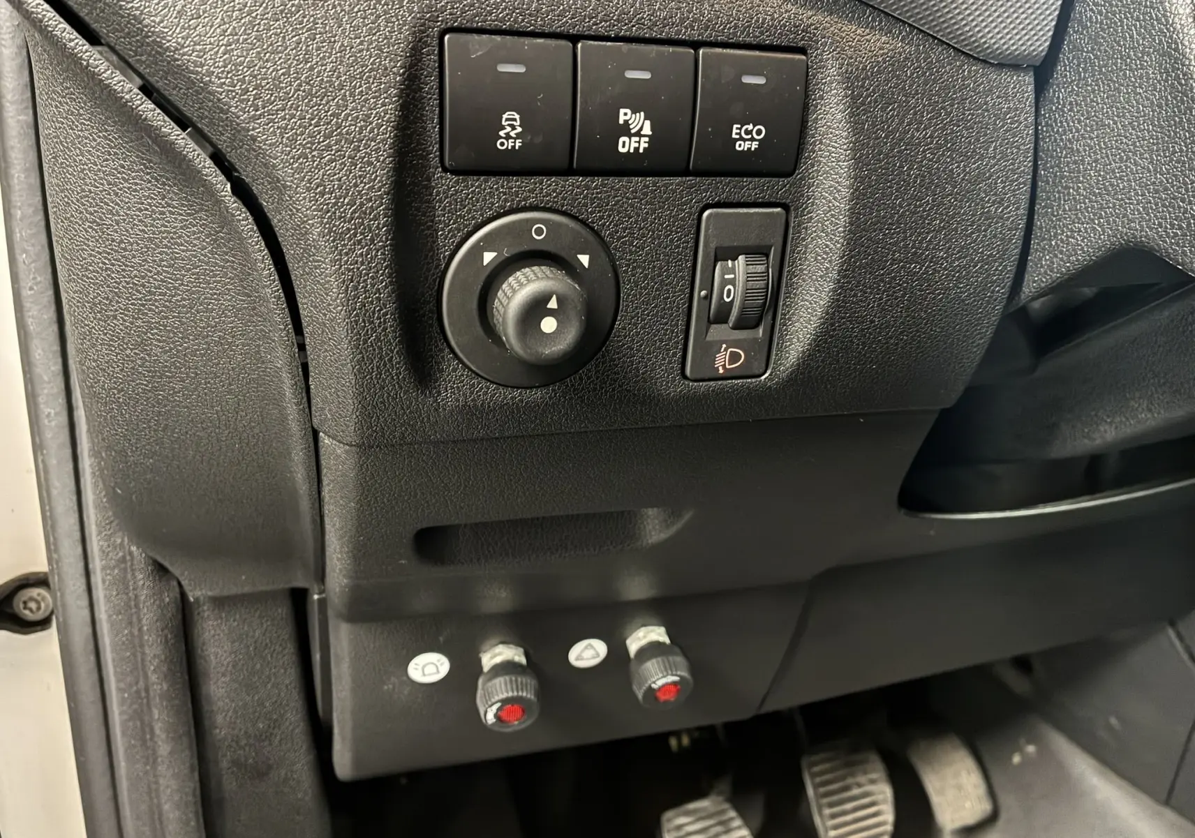 Vue rapprochée des commandes noires côté conducteur du tableau de bord du Citroën Berlingo blanc 2016.