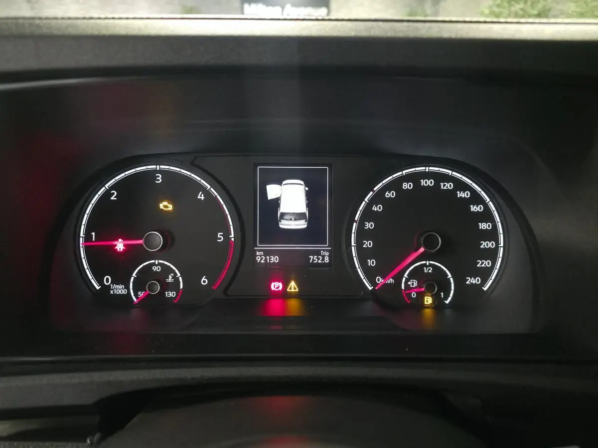 Vue rapprochée du combiné d'instruments du Volkswagen Caddy Cargo 2.0 TDI 2022, affichage numérique et compteurs analogiques.