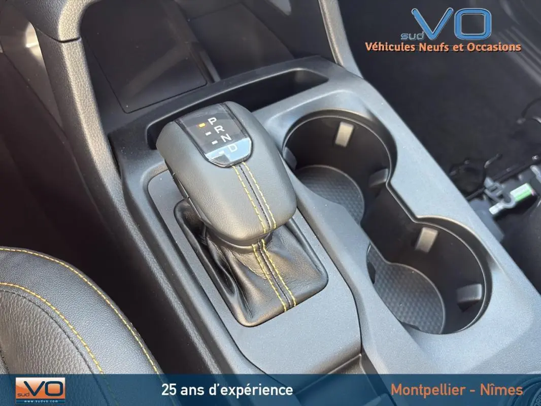 Gros plan sur la commande de boîte automatique et les porte-gobelets du Ford Ranger noir version Wildtrak 2025.