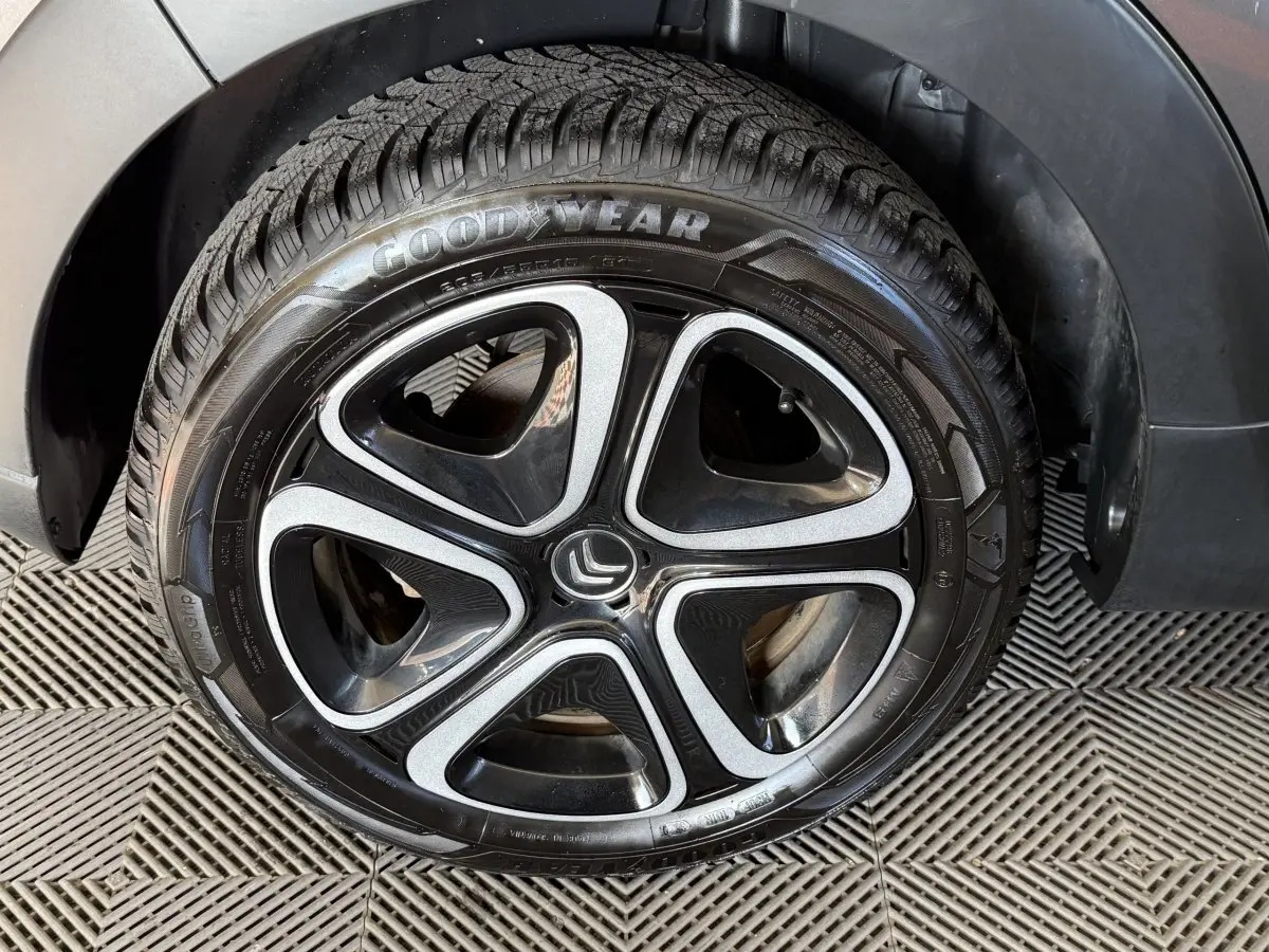 Gros plan sur la roue avant droite de la Citroën C3 gris clair, avec jante alliage noire et argentée et pneu Goodyear.