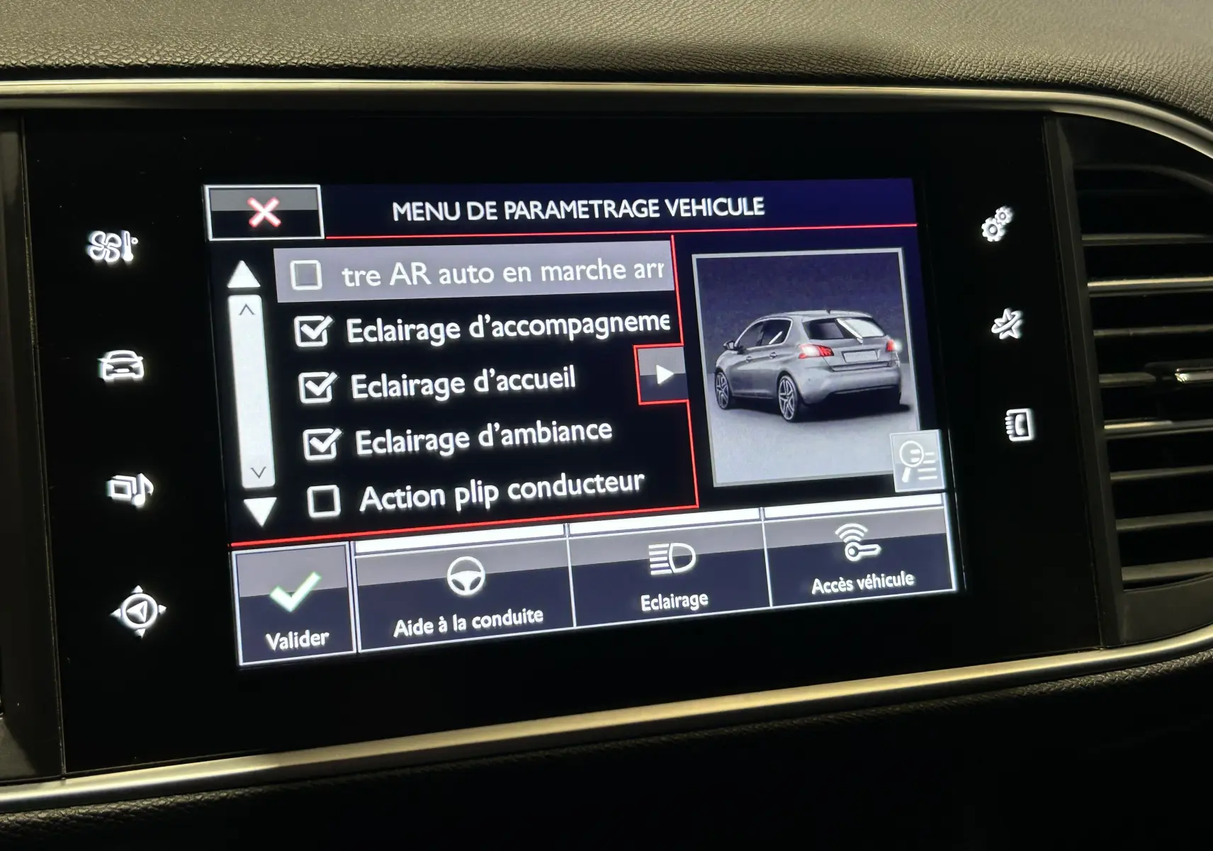 Écran tactile du menu de paramétrage véhicule montrant une Peugeot 308 grise en vue 3/4 arrière droite.