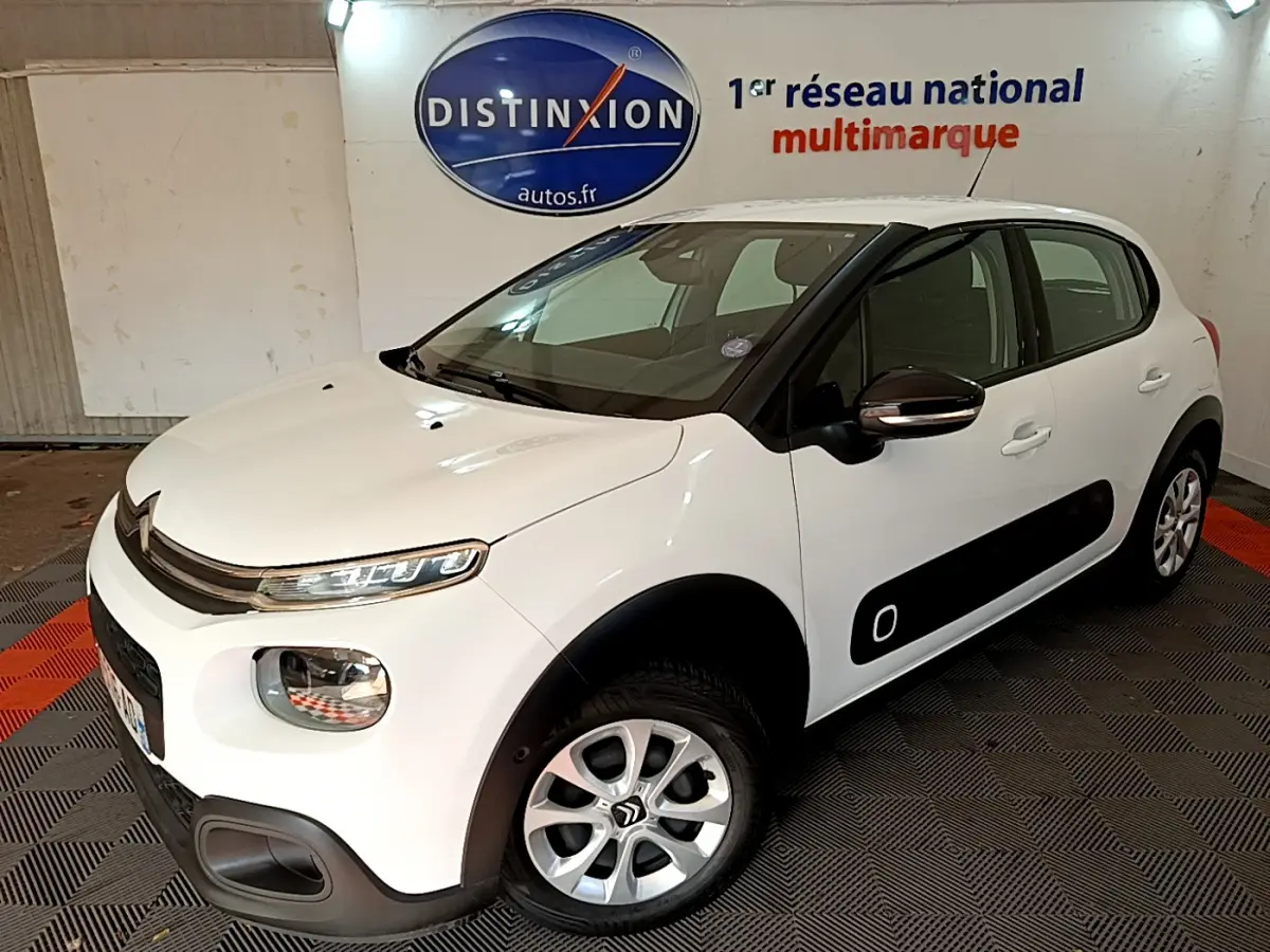 Citroën C3 blanche vue en 3/4 avant droit avec protections latérales noires et jantes alliage.