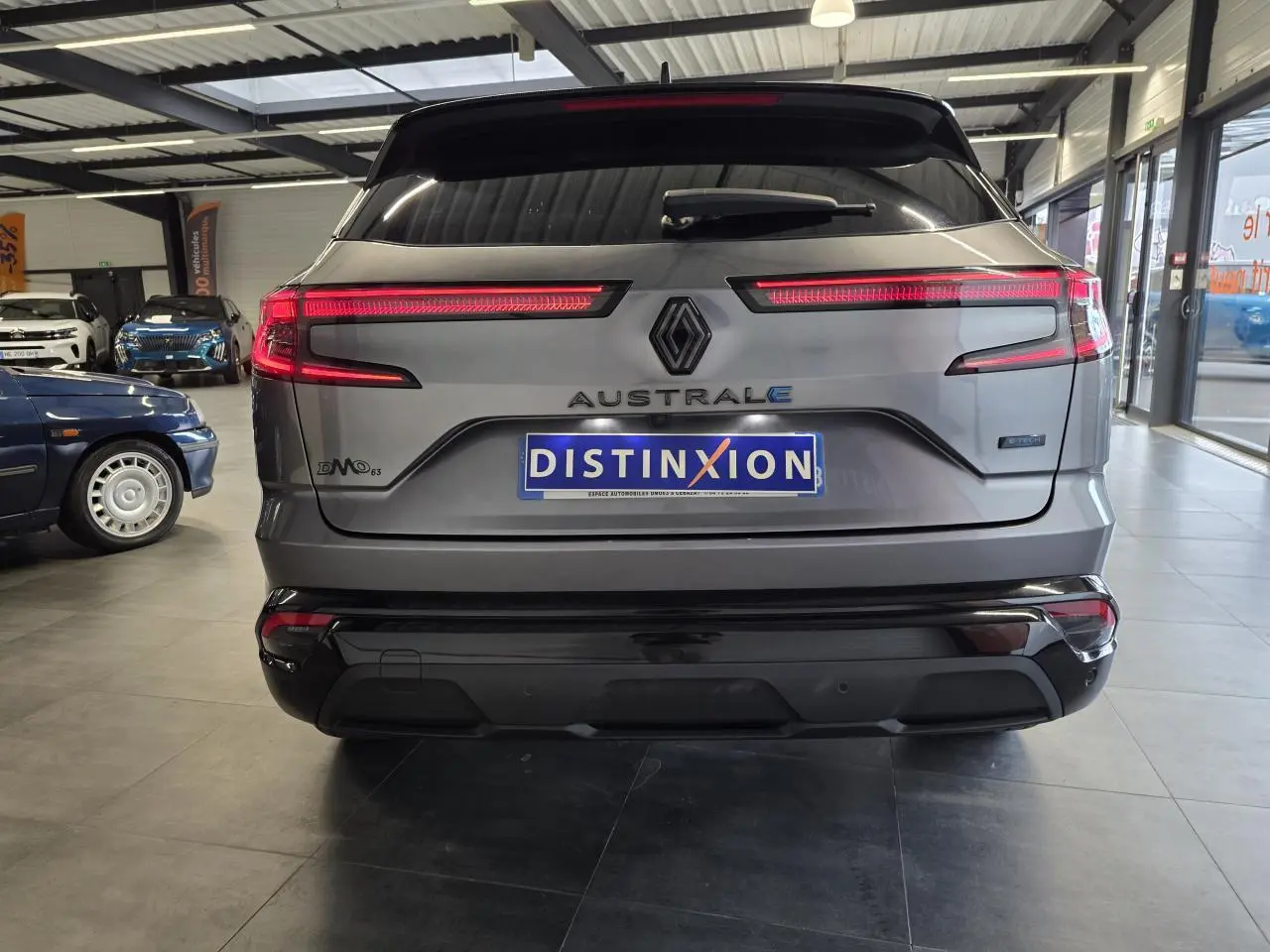 Vue arrière du Renault Austral gris foncé avec feux LED allumés et logo distinctif au centre du hayon.